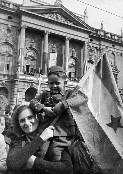 People on the streets of belgrade, yugoslavia during a celebration of the first anniversary of liberation from the germans