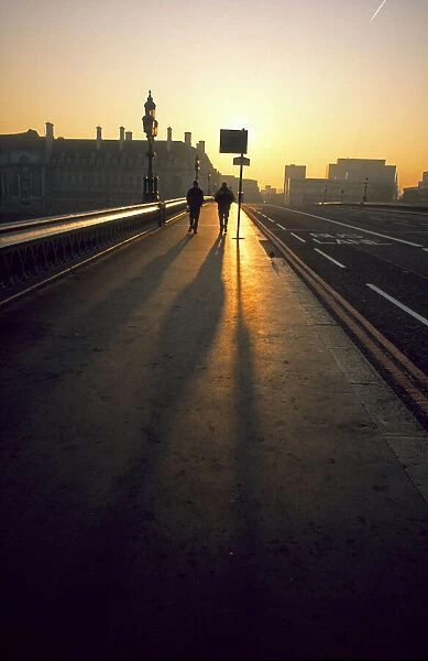 Two people on Westminster Bridge at sunrise