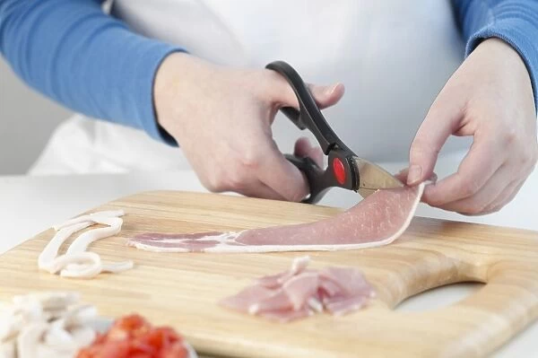 Person cutting bacon with scissors