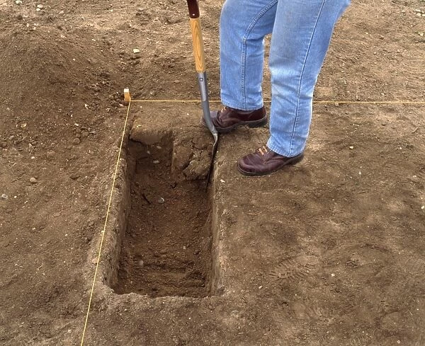 Person digging with spade in area marked-out with string