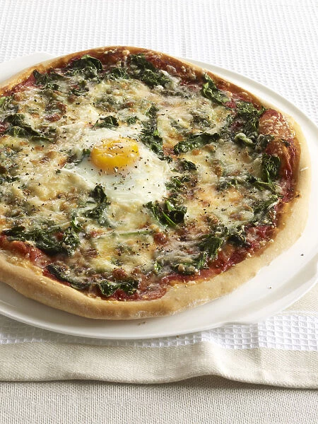 Pizza Florentina, topped with spinach, cheese and egg, close-up