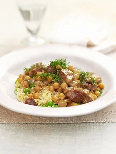 Plate of lamb, bulgur wheat and chickpeas, close-up