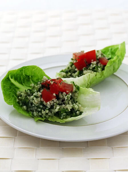 Plate of Tabbouleh on lettuce leaf, close-up