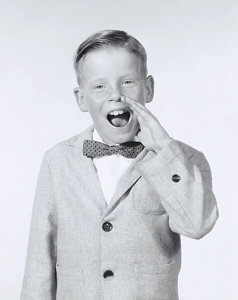 Portrait of boy calling out wearing a bow tie