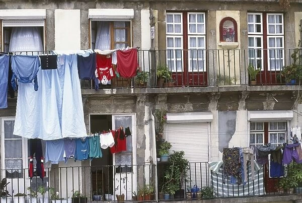 Portugal, Oporto, Barredo, washing hanging from lines on balconies of old houses