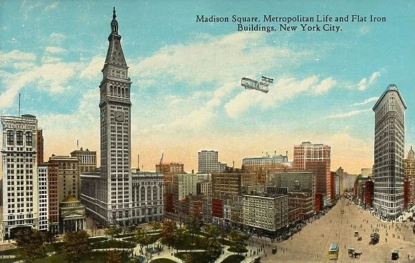 Postcard of Madison Square. ca. 1913, Madison Square, Metropolitan Life and Flat Iron Buildings, New York City. Madison Square showing Fifth Avenue at Right crossed by Broadway at 23rd Street. This tract was set apart in 1811 for parade grounds, 6. 84 acres of which still remain. It is bounded by Broadway and Madison Avenue and 23rd and 26th Streets. It was for a generation the centre of the Hotel and Theatre district