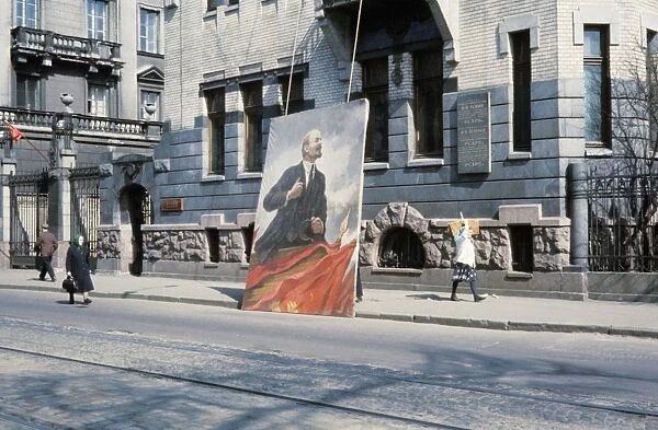 A poster of lenin being put up for may day in leningrad, 1968