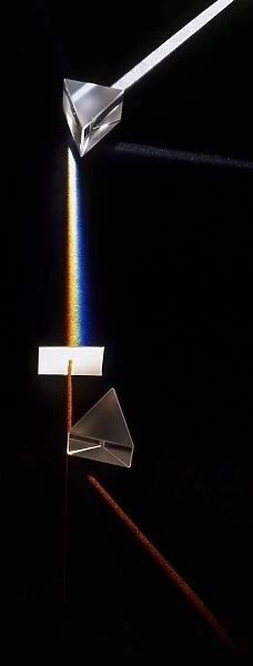 Prism splitting white light ray into colours of the visible spectrum, side view