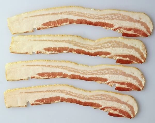Four rashers of streaky bacon, view from above