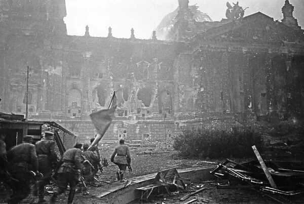 Red army soldiers carrying their battle standard storm the reichstag, berlin, 1945, world war 2