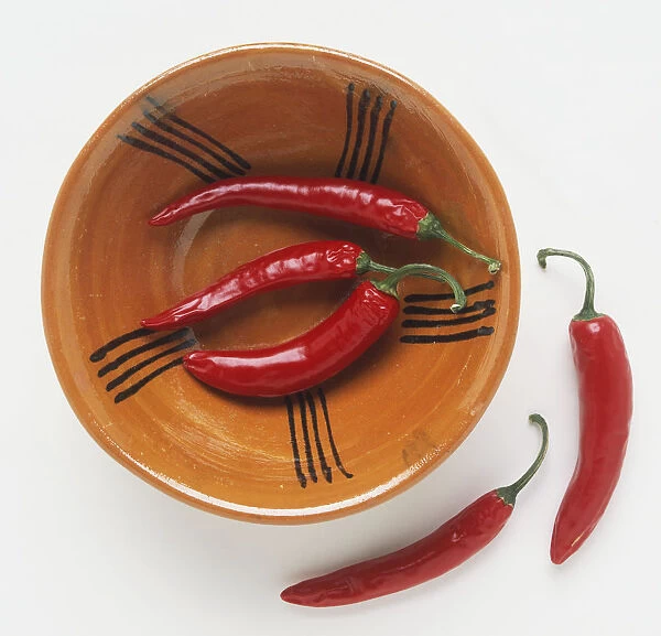 Red chili peppers in an orange bowl