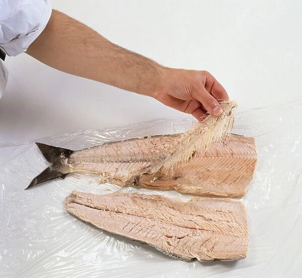 Removing bones from poached salmon fillet