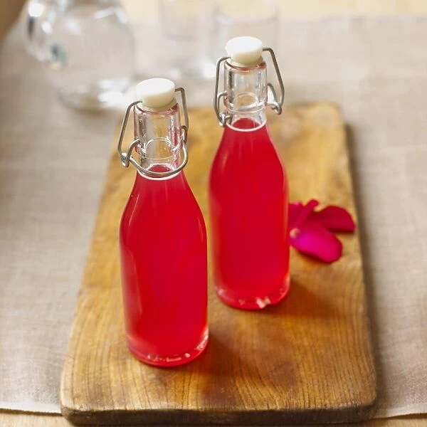 Rhubarb and rose petal syrup in two bottles