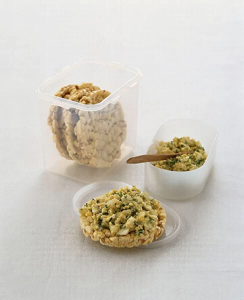 Rice cakes with egg and herb topping, in plastic containers