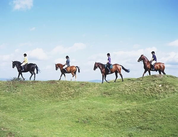 Four Riders on Ponies Riding Along Bridleway