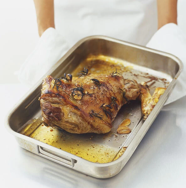 Roast lamb in a roasting pan, high angle view