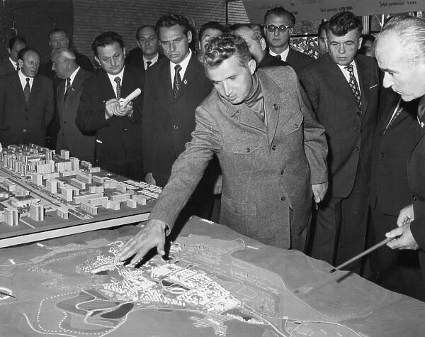 Romanian president nicolaae ceausescu talks with experts and town councillors about the extension of the iron and steel combine and development of hunedoara town, romania, 1970s