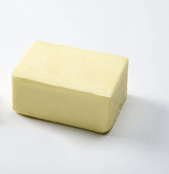 Salted butter on white background, close-up