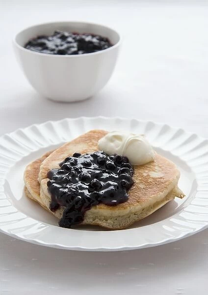 Scotch pancake with blueberry jam and cream, close-up
