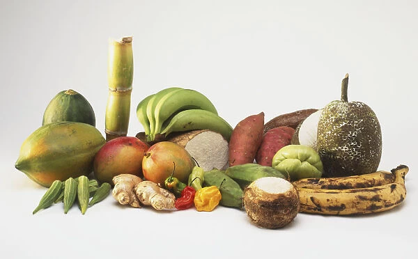 A selection of Caribbean fruit and vegetables, including okra, mangoes, papaya, sugar cane, green bananas, yam, sweet potato, chow, cassava, blogo, dasheen, bread fruit and plantain