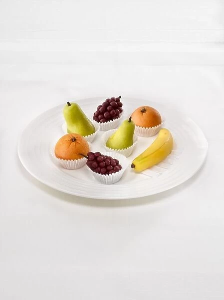 Selection of marzipan fruit arranged on a plate, close-up
