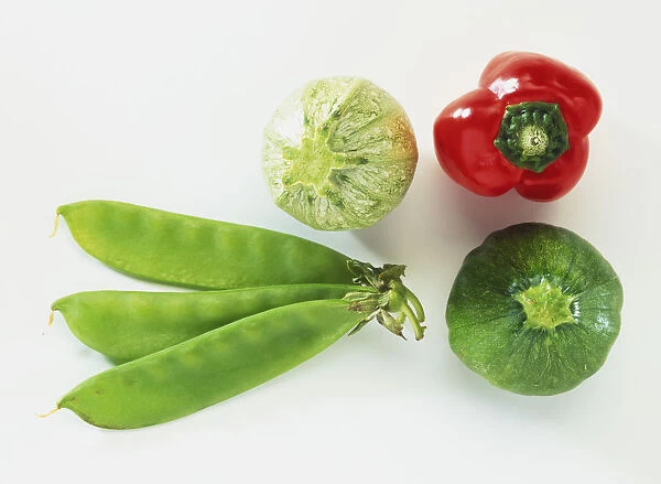 Selection of vegetables, including baby marrows, small red pepper and mangetout, view from above