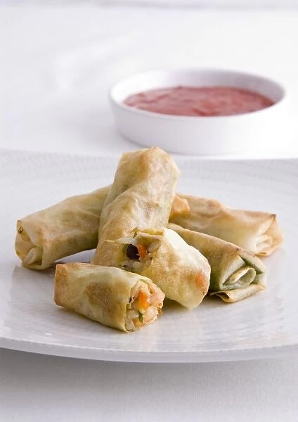 Shrimp spring rolls served with chilli dipping sauce, close-up