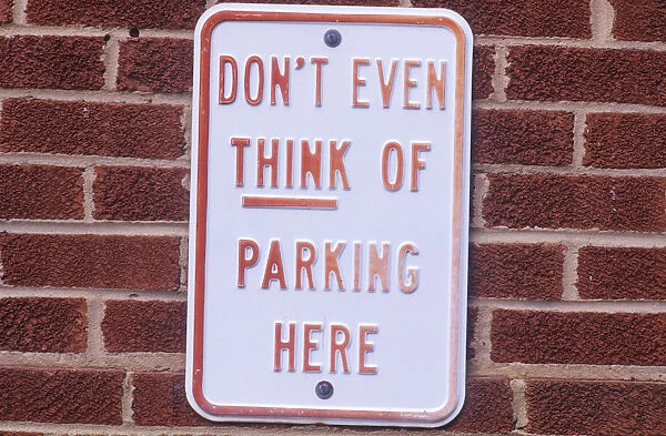 A sign that reads Don t even think of parking here”