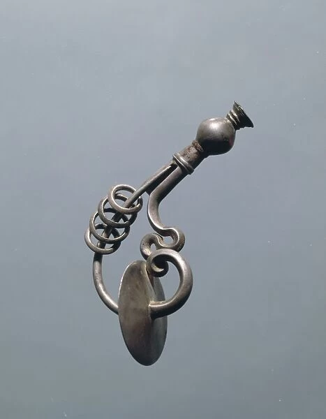Silver fibula with rings on needle
