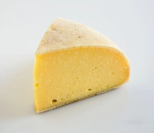 Slice of American Thomasville Tomme cows milk cheese