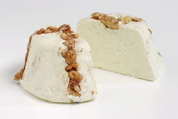 Sliced cone of Israeli Turkeez goats cheese with walnuts