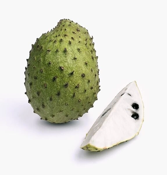 Whole and sliced guanabana (soursop) on white background, close-up