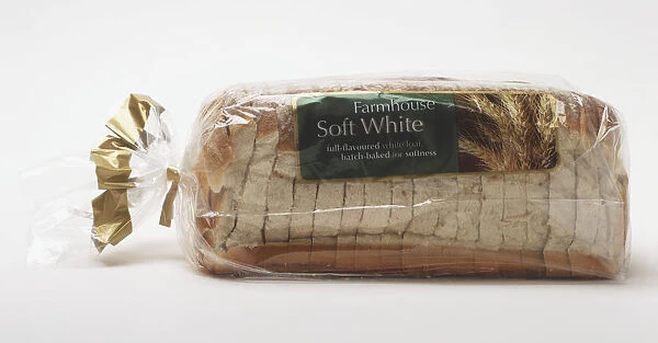 Sliced loaf of soft white bread in clear plastic packaging, side view