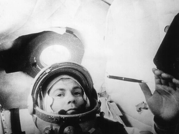 Soviet cosmonaut pavel popovich in the cabin of vostok 4 demonstrating weightlessness by floating a pen