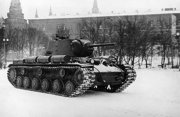 A soviet kv1 tank damaged in battle passing the moscow kremlin on the way back to the front after repairs, world war 2, ussr