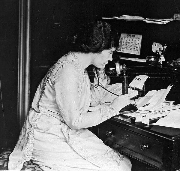 Suffragist Alice Paul using telephone