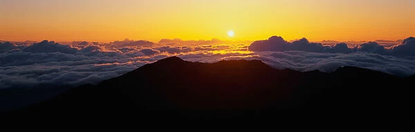 This is sunrise from Haleakala Volcano Summit located at Haleakala National Park. These are the cloud formations over the top of the volcano