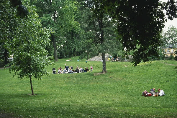 Sweden, Stockholm, a group of people relaxing in Vasaparken, a green lung in the built-up area of Vasastan