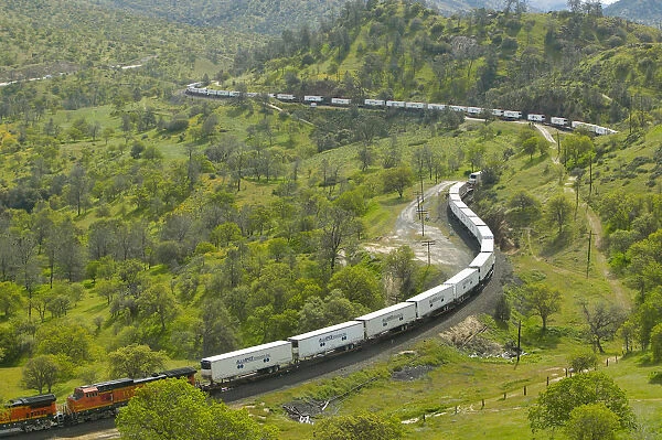 The Tehachapi Train Loop near Tehachapi California is the historic location of the Southern Pacific Railroad where freight trains gain 77 feet in elevation and show freight cars traveling in giant loop
