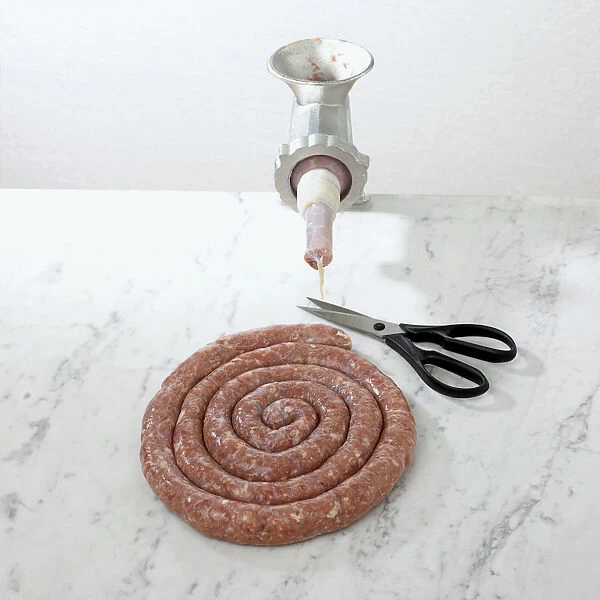 Toulouse sausage with sausage maker and scissors