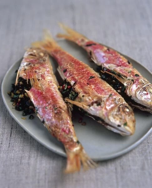 Triglie di scoglio, Sicilian pan-fried red mullet stuffed with olives and herbs, on a plate