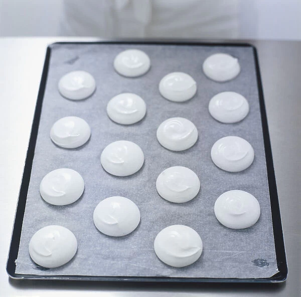 Uncooked meringues on baking tray, view from above