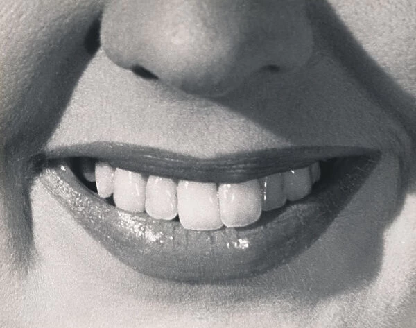 United States: c. 1960. A closeup of a smiling womans mouth