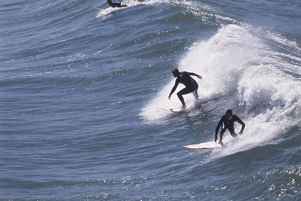 USA, California, Huntington Beach, two surfers riding waves