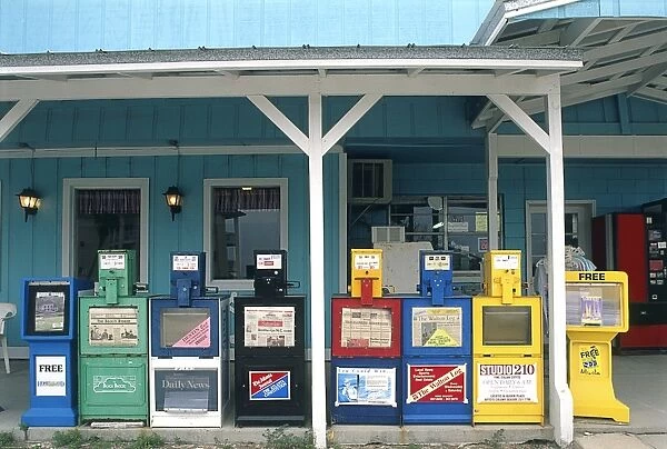 USA, Florida, Palm Beach, newspaper vending machines aligned on a veranda