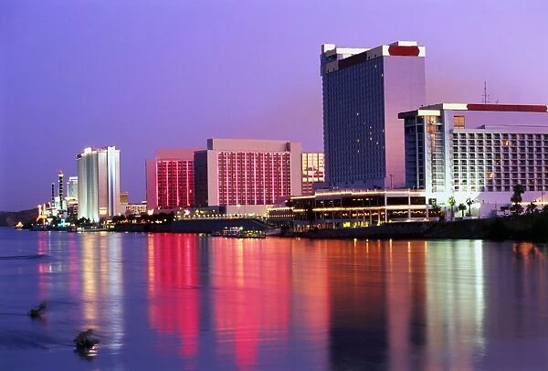 USA, Nevada, Las Vegas, Casino Row, floodlit buildings reflcted in water at night