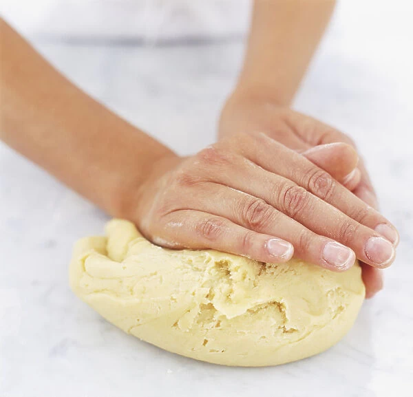 Using hands to knead dough, close up