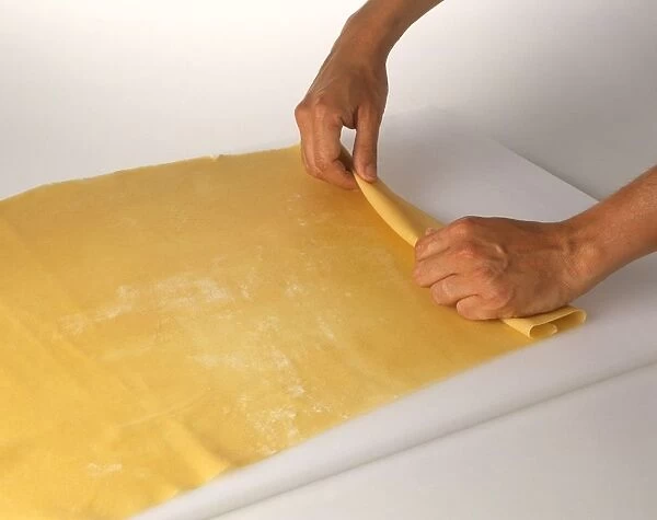 Using hands to roll past dough