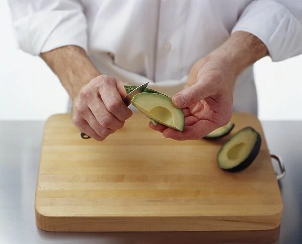 Using kitchen knife to remove skin from avocado