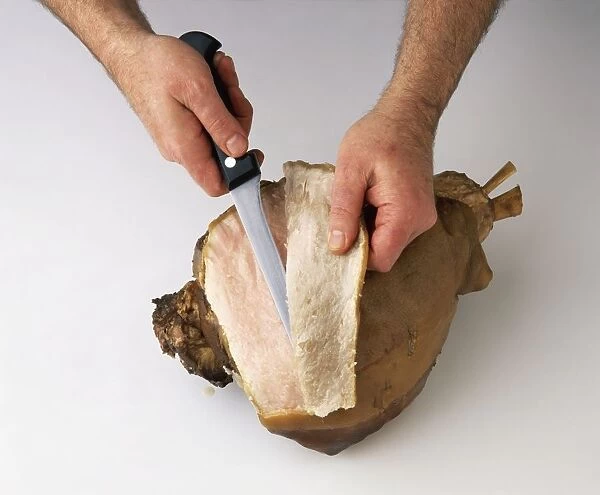 Using kitchen knife to remove skin from cured ham